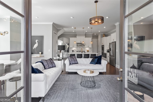 living room with crown molding and hardwood / wood-style floors