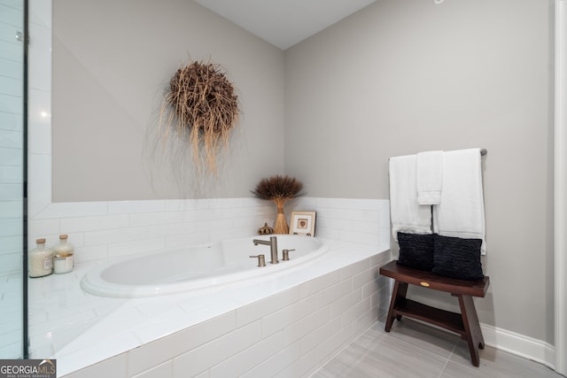 bathroom featuring tiled bath