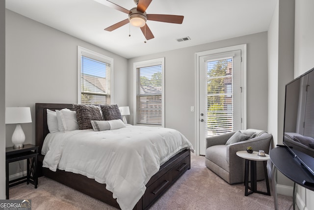 bedroom featuring ceiling fan, light colored carpet, and access to exterior