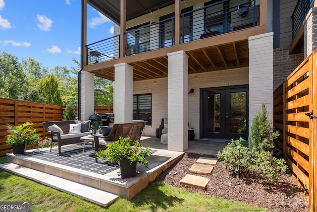 exterior space with outdoor lounge area, french doors, and a patio area