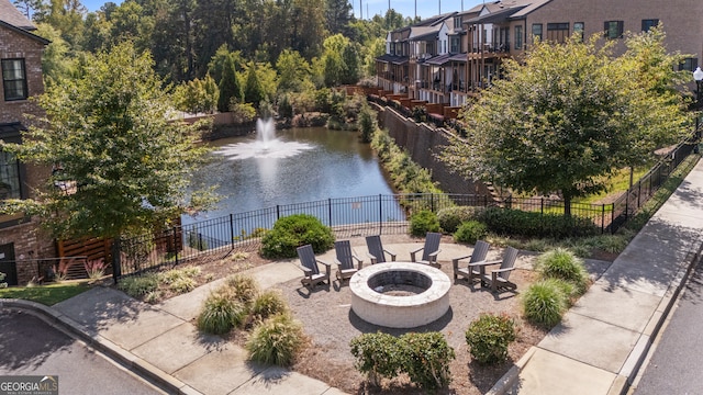 exterior space with a water view and an outdoor fire pit