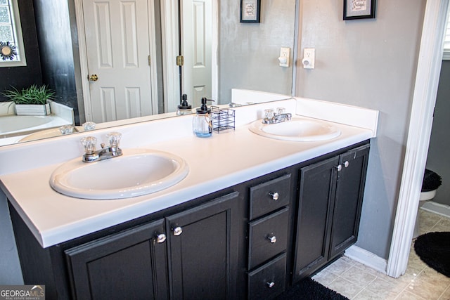 bathroom with tile patterned floors and vanity