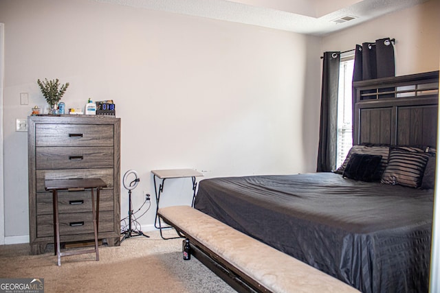 carpeted bedroom with a textured ceiling