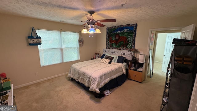 carpeted bedroom with a textured ceiling and ceiling fan