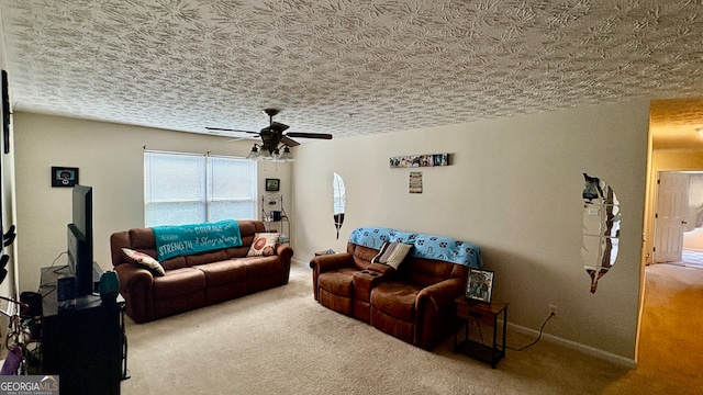 living room featuring ceiling fan, carpet floors, and a textured ceiling