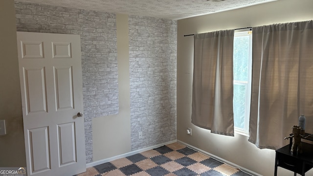 spare room featuring a textured ceiling