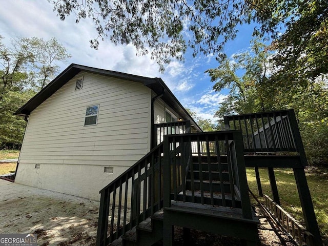 view of property exterior with a deck