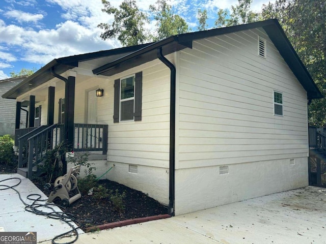 view of property exterior featuring covered porch