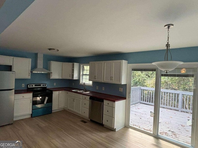 kitchen featuring fridge, stainless steel dishwasher, plenty of natural light, and electric range oven