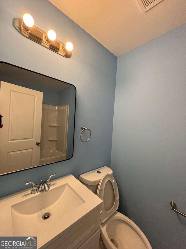 bathroom with vanity and toilet