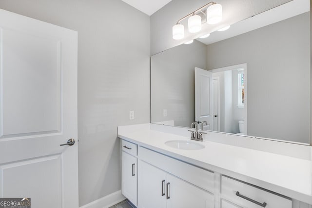 bathroom featuring vanity and toilet