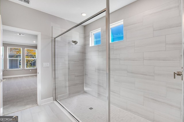 bathroom featuring a shower with door