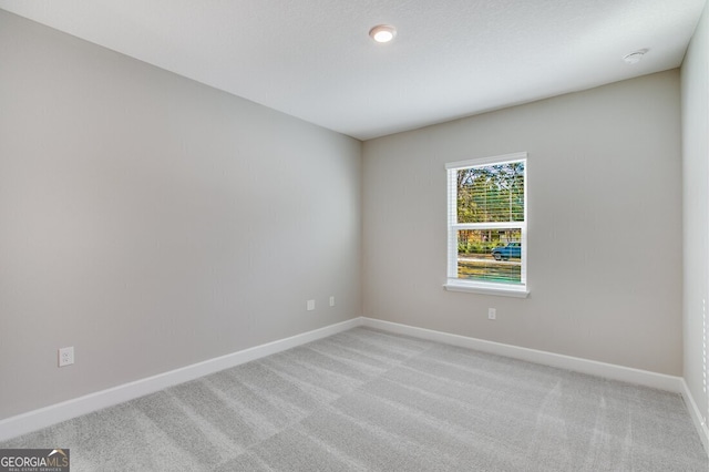 spare room with light colored carpet