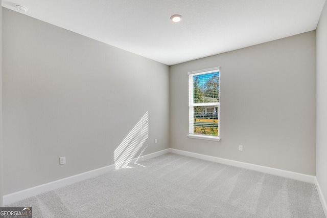 unfurnished room with light colored carpet