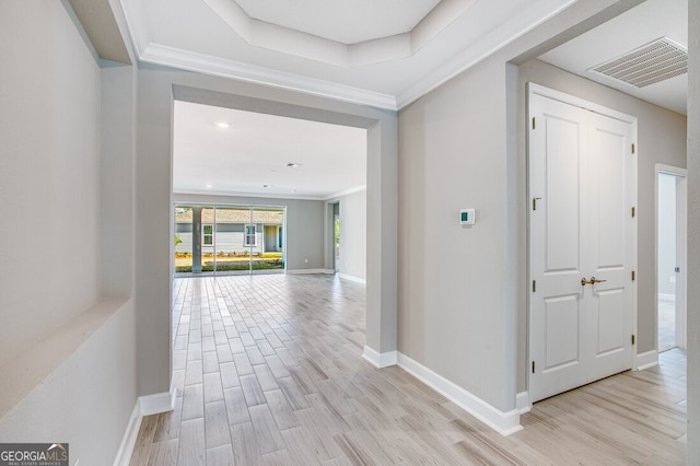 corridor with crown molding and light hardwood / wood-style floors