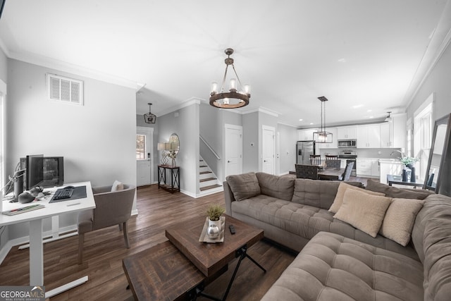 living room with ornamental molding, dark hardwood / wood-style flooring, a chandelier, and sink