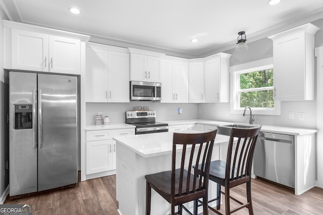 kitchen featuring appliances with stainless steel finishes, dark hardwood / wood-style flooring, and white cabinetry