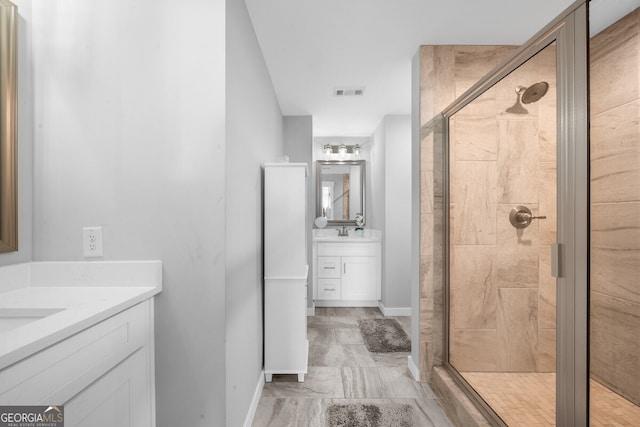 bathroom featuring walk in shower and vanity