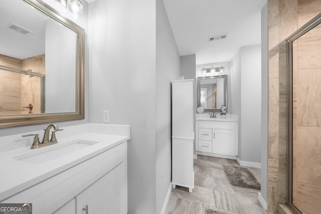 bathroom featuring vanity and a shower with shower door