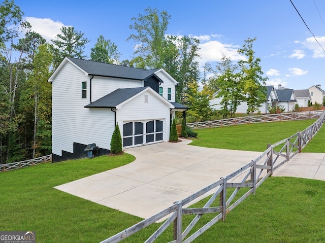 back of property with a garage and a yard