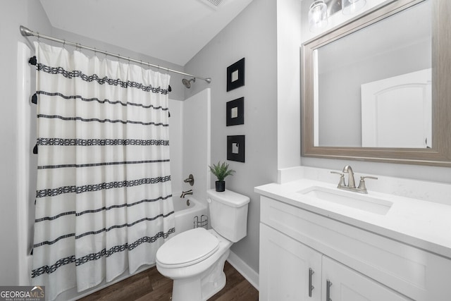 full bathroom with wood-type flooring, shower / tub combo with curtain, vanity, and toilet