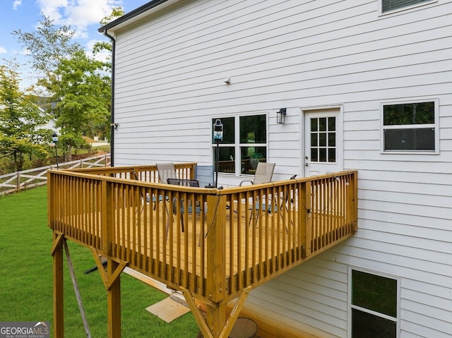 wooden deck with a lawn