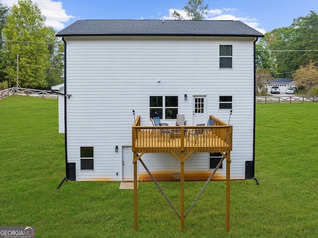 back of house featuring a yard and a deck