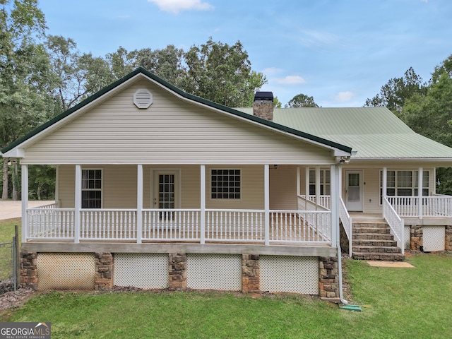 view of front of house with a front yard and a porch