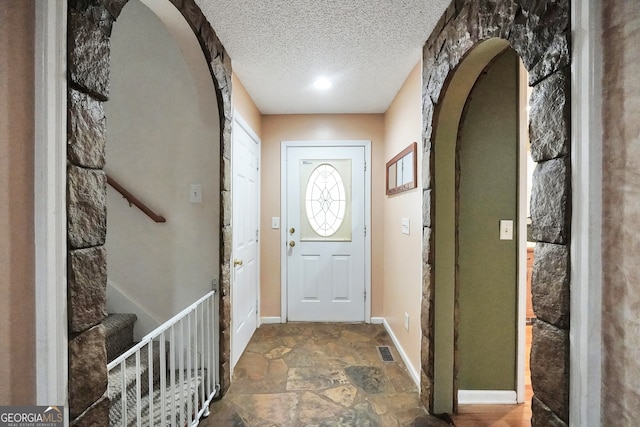 entryway featuring a textured ceiling