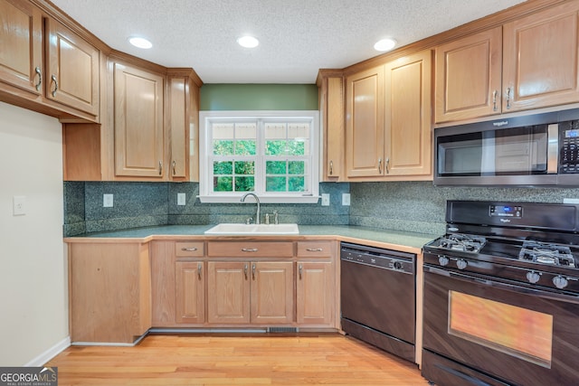 kitchen with decorative backsplash, a textured ceiling, black appliances, light hardwood / wood-style flooring, and sink