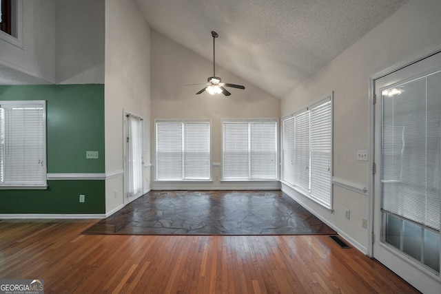 entryway featuring ceiling fan, a textured ceiling, dark hardwood / wood-style flooring, and high vaulted ceiling