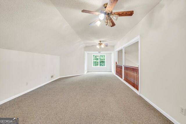 unfurnished bedroom featuring ceiling fan, a textured ceiling, and dark colored carpet