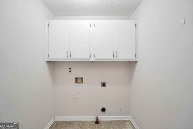 washroom with washer hookup, a textured ceiling, hookup for a gas dryer, electric dryer hookup, and cabinets