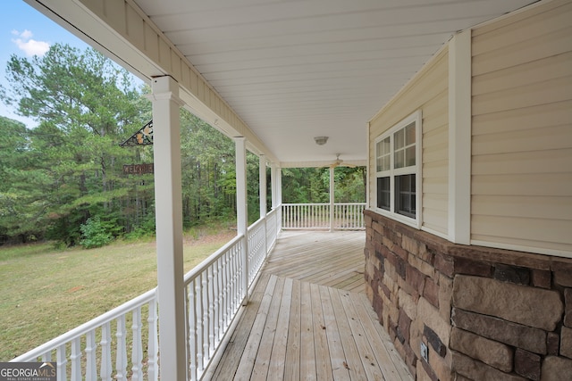 wooden terrace with a yard