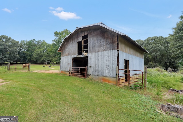 view of outbuilding featuring a yard