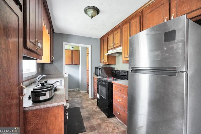 kitchen featuring a textured ceiling, sink, and black appliances