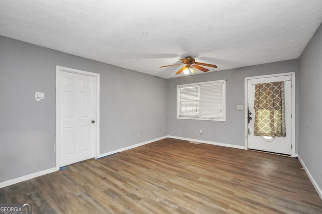 spare room featuring ceiling fan, a textured ceiling, and hardwood / wood-style floors