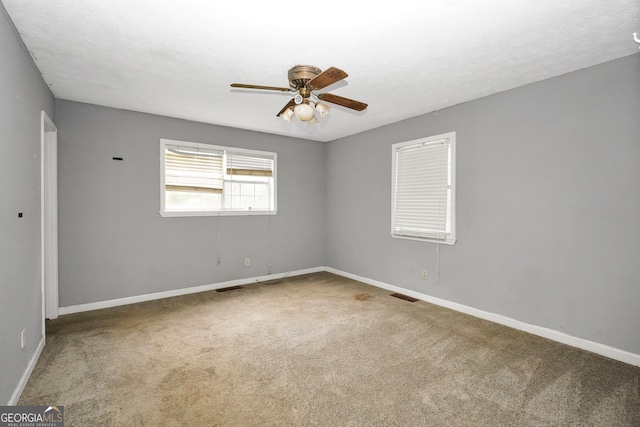 empty room with carpet floors and ceiling fan