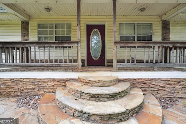 entrance to property featuring covered porch