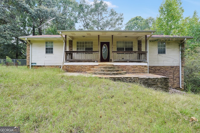 single story home featuring covered porch and a front yard