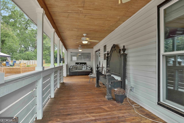 unfurnished sunroom with vaulted ceiling, ceiling fan, and wooden ceiling