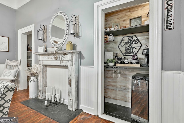 details with wine cooler, wood walls, and hardwood / wood-style floors