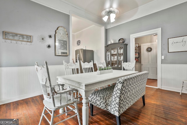 dining room featuring ornamental molding, ceiling fan, and dark hardwood / wood-style flooring