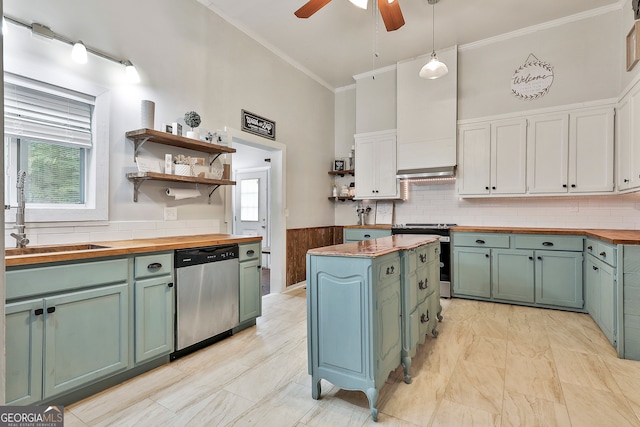 kitchen featuring pendant lighting, butcher block counters, appliances with stainless steel finishes, and a healthy amount of sunlight