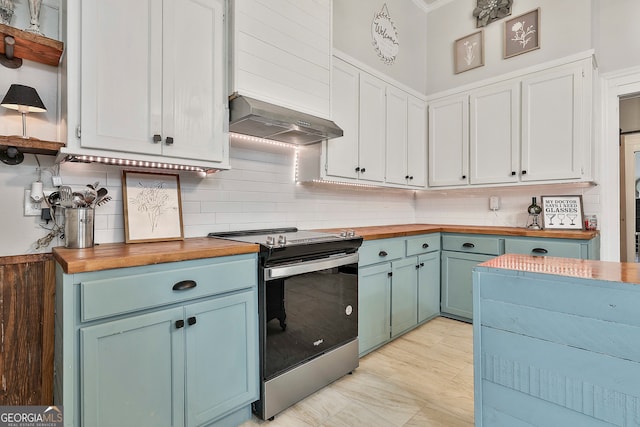 kitchen featuring stainless steel range with electric stovetop, white cabinets, wall chimney range hood, and wood counters