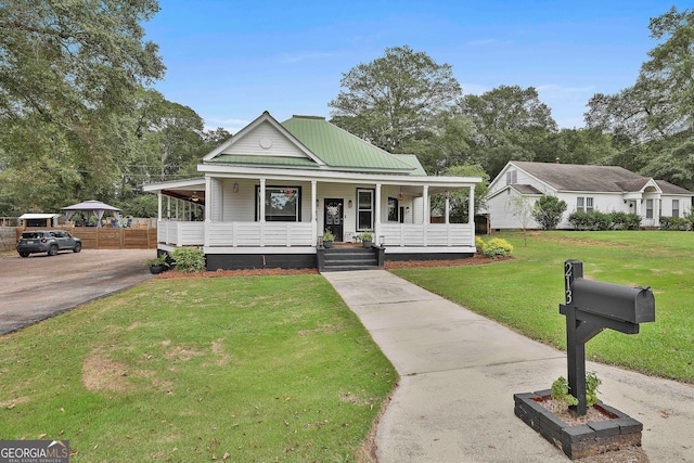 farmhouse with a front lawn and a porch