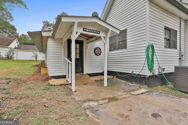 view of exterior entry with central AC unit