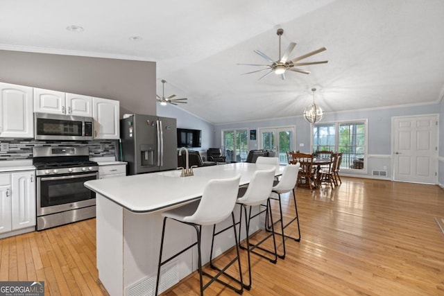 1011 Sugar Hill Way, Buckhead, GA 30625 - kitchen with ceiling fan with notable chandelier, open floor plan, white cabinetry, a sink, and appliances with stainless steel finishes