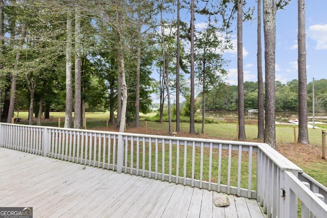 wooden terrace with a lawn