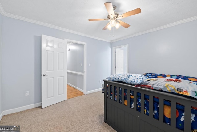 bedroom featuring ceiling fan, crown molding, and light carpet